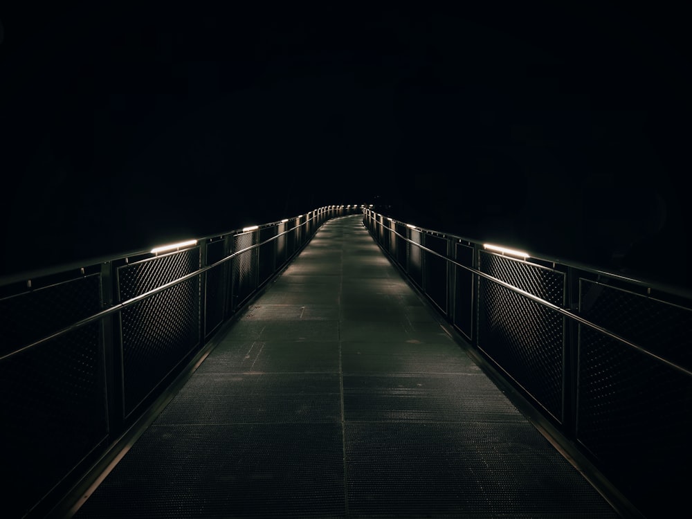brown wooden bridge with light during night time