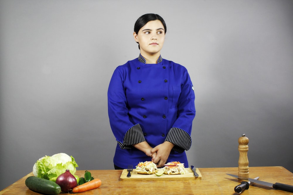 woman in blue dress shirt sitting on chair