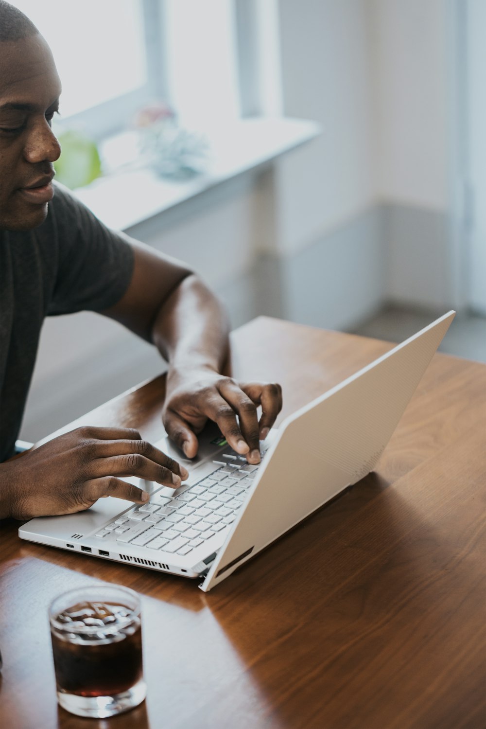 man in gray crew neck t-shirt using laptop