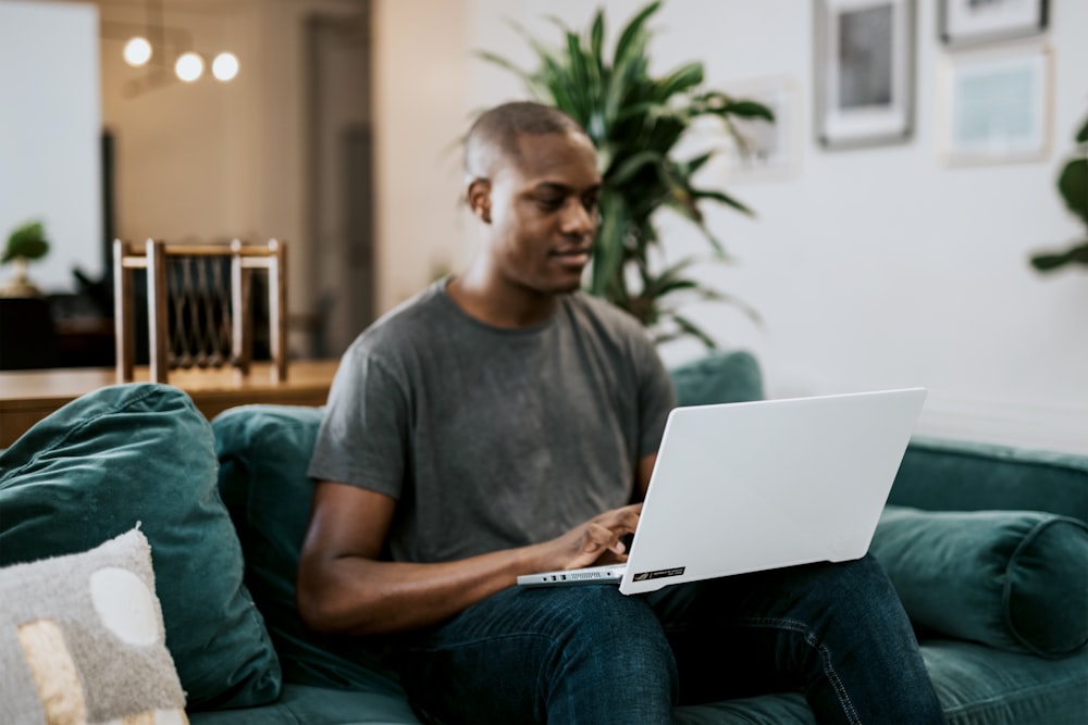 man in gray crew neck t-shirt using laptop