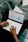 A professional client happily using a laptop to schedule an appointment online.