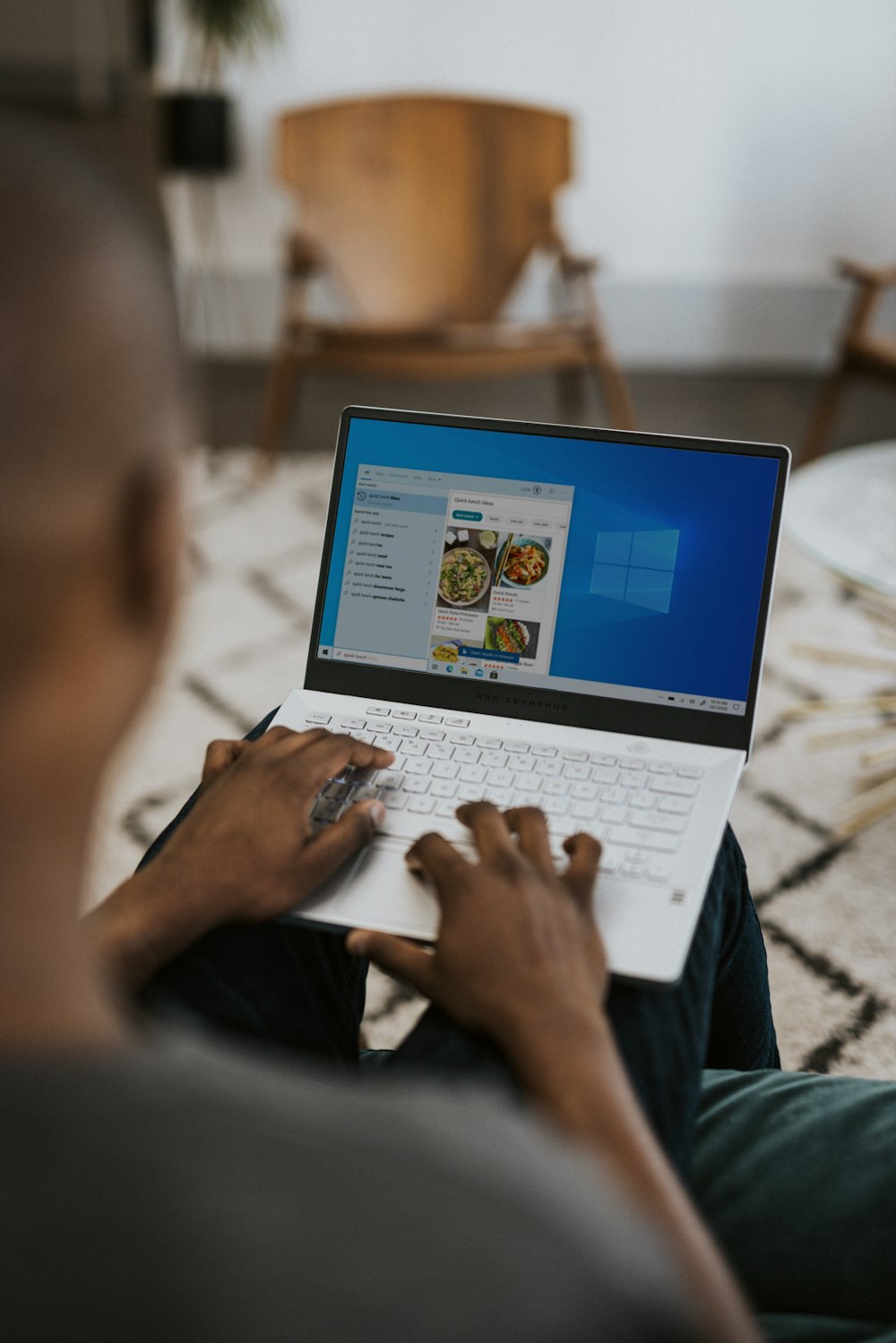 person using laptop on bed