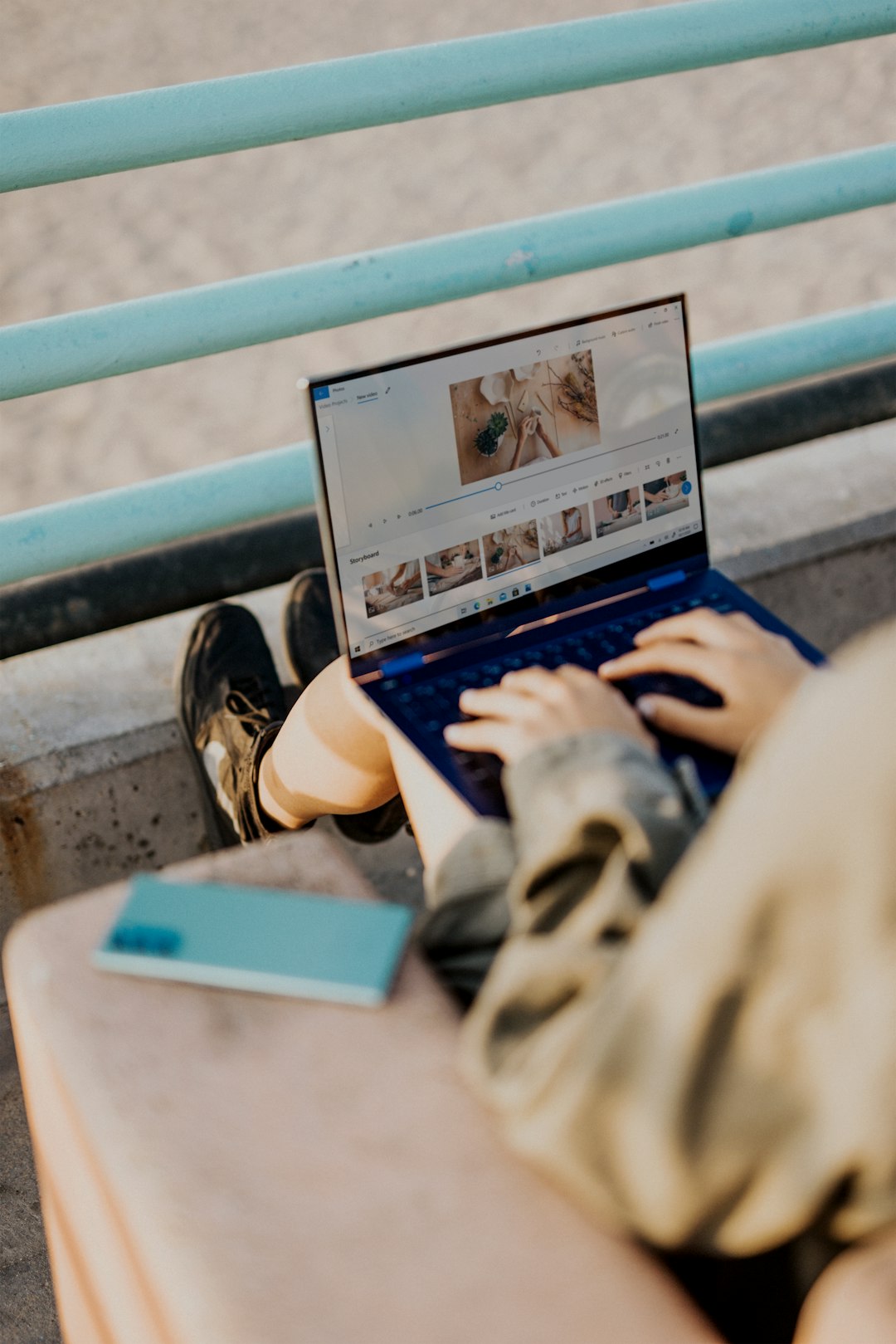 person in gray jacket using blue laptop computer