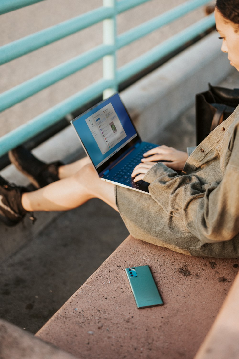 person in brown robe using black laptop computer