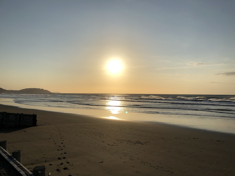 silhouette of people on beach during sunset