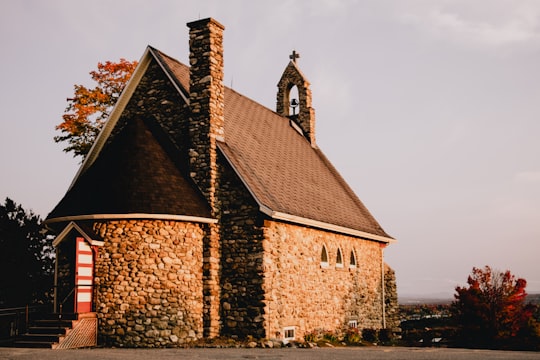 brown brick building under gray sky in Cantons-de-l'Est Canada