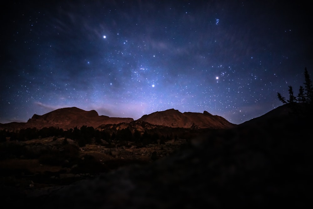 brown mountain under blue sky during night time