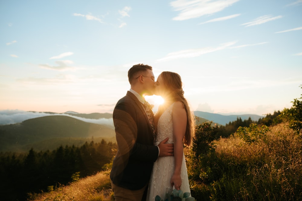 man and woman standing on green grass field during daytime