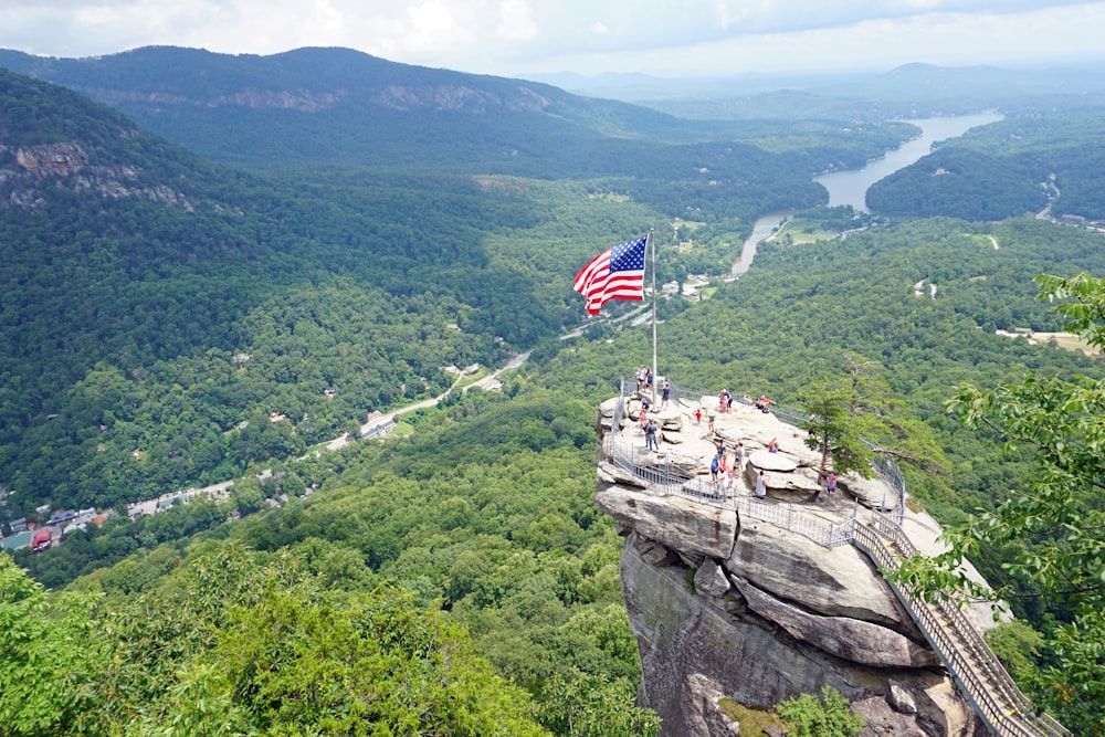 us a flag on top of mountain during daytime