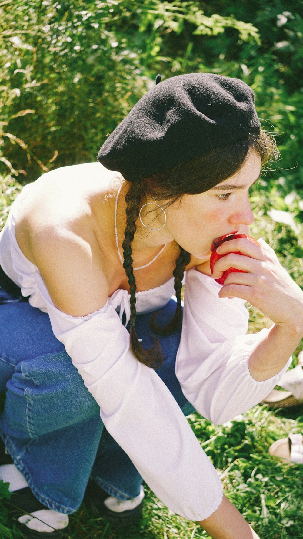 woman in white tank top and blue denim jeans sitting on ground