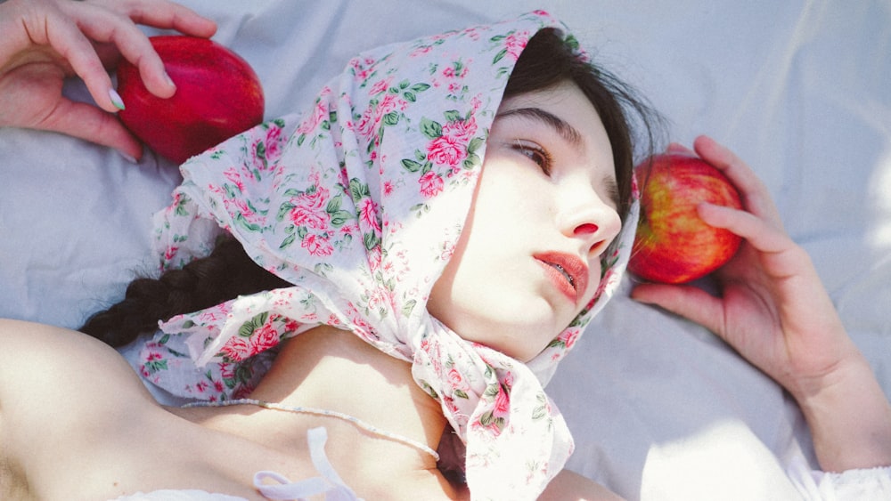 woman in white red and green floral hijab