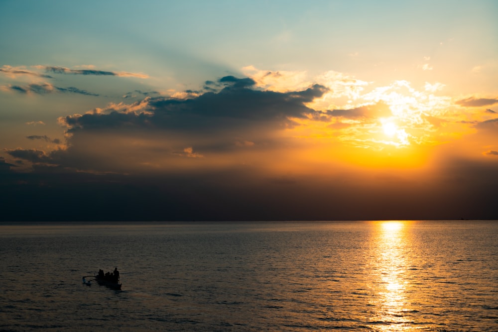 silhouette of people on beach during sunset