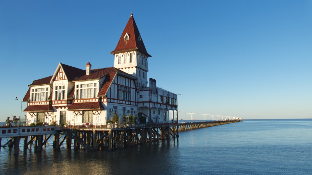 white and brown concrete building beside body of water during daytime