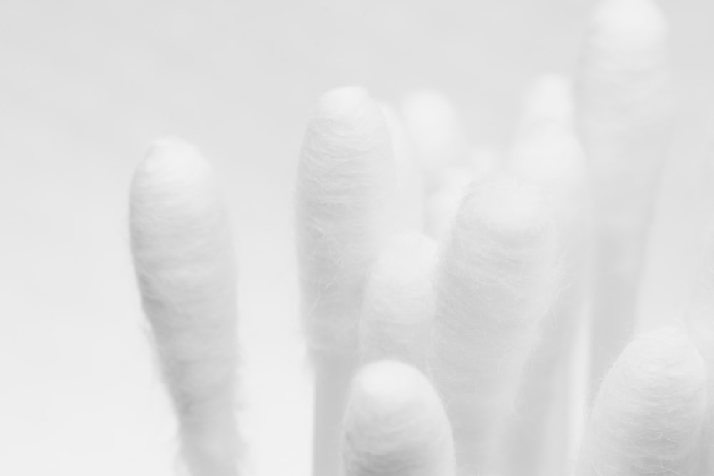 persons hand on white textile