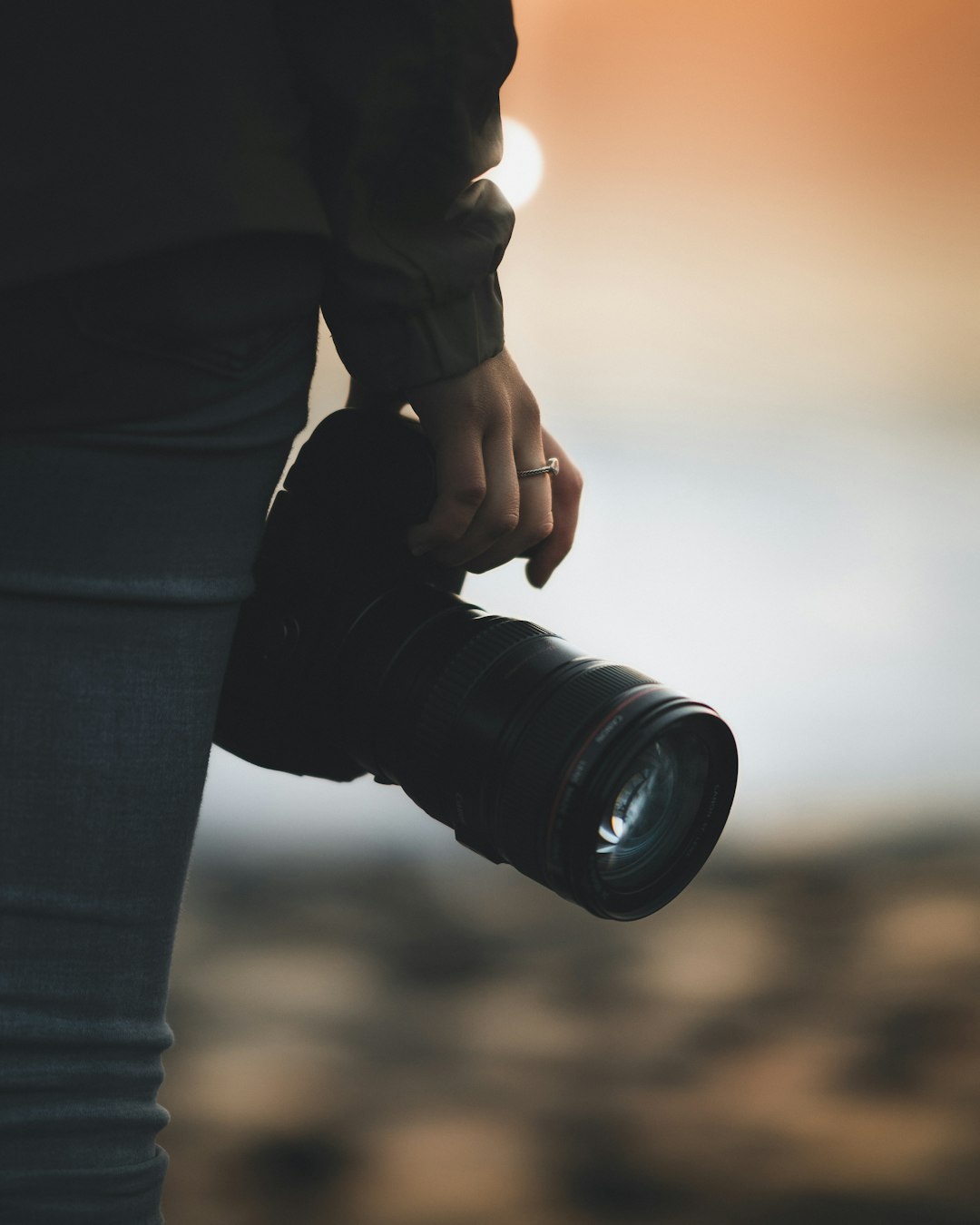 person holding black dslr camera lens