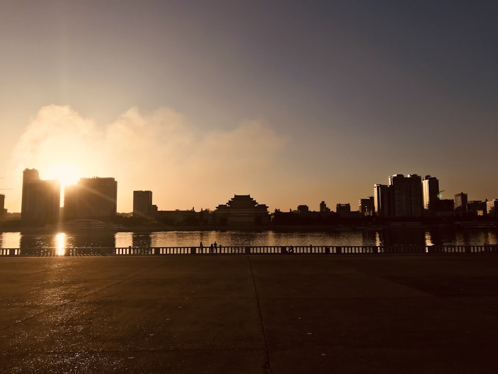 silhouette of city buildings during sunset