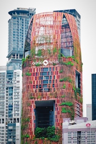 A sleek skyscraper with vertical gardens climbing its facade.