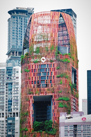 A sleek skyscraper with vertical gardens climbing its facade, merging urban design with nature.