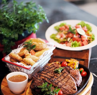 grilled meat with vegetable on brown wooden round tray