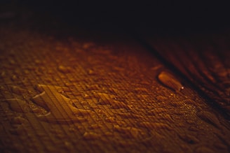 Close-up of moisture-level analysis device on a polished wood surface with natural light.