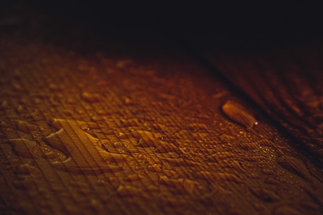 Close-up of moisture-level analysis device on a polished wood surface with natural light.