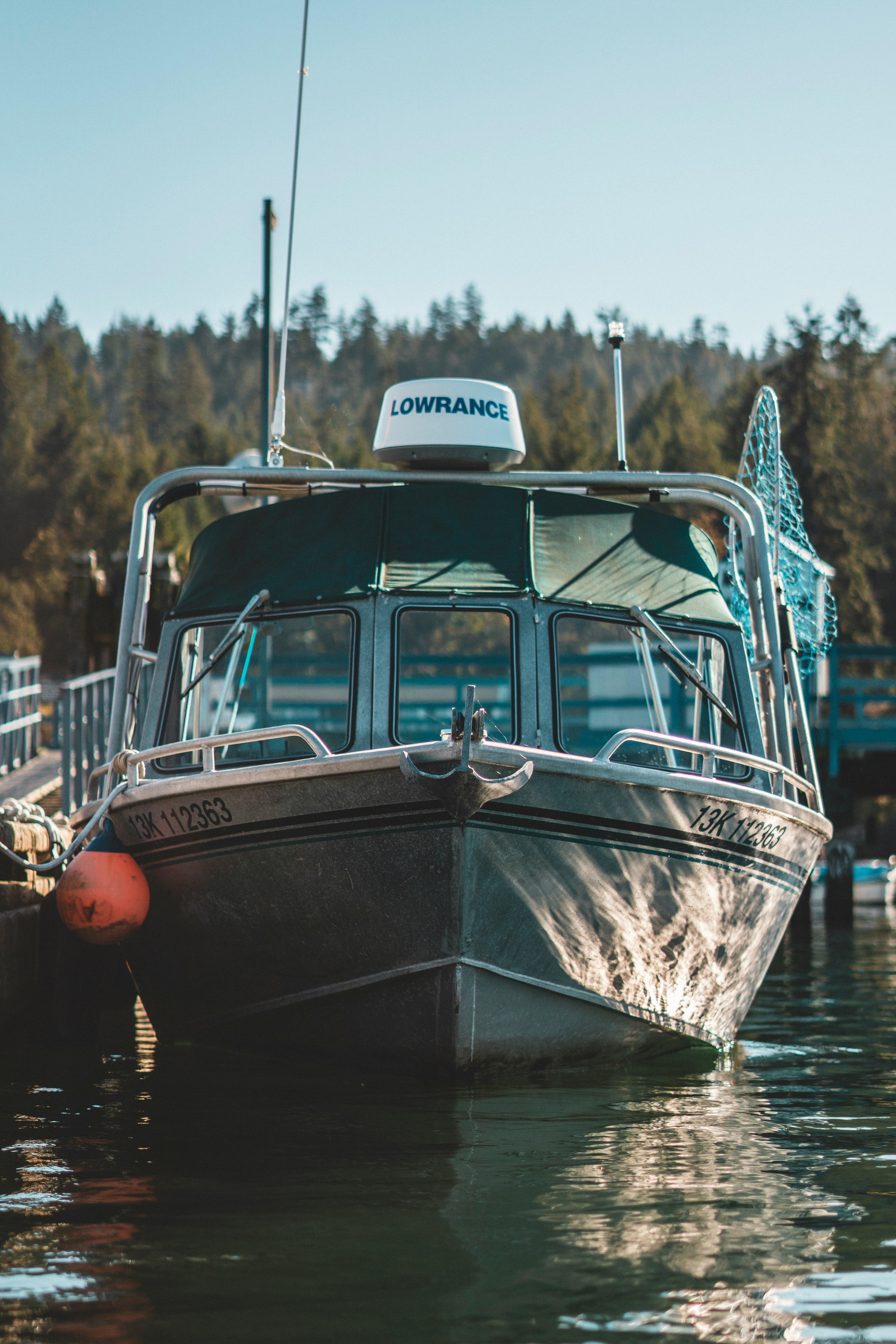 white and blue boat on water during daytime