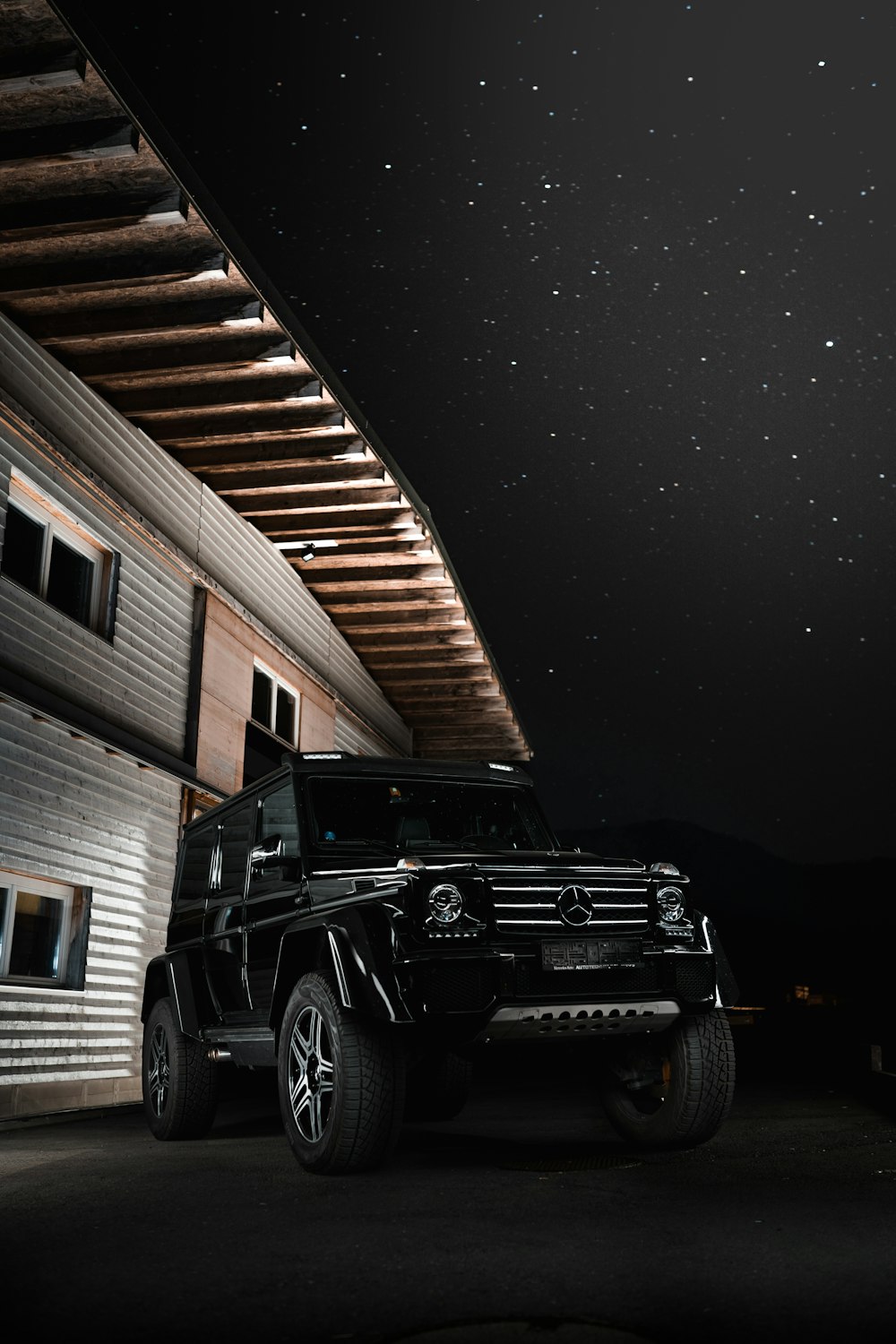 black jeep wrangler parked near brown wooden wall