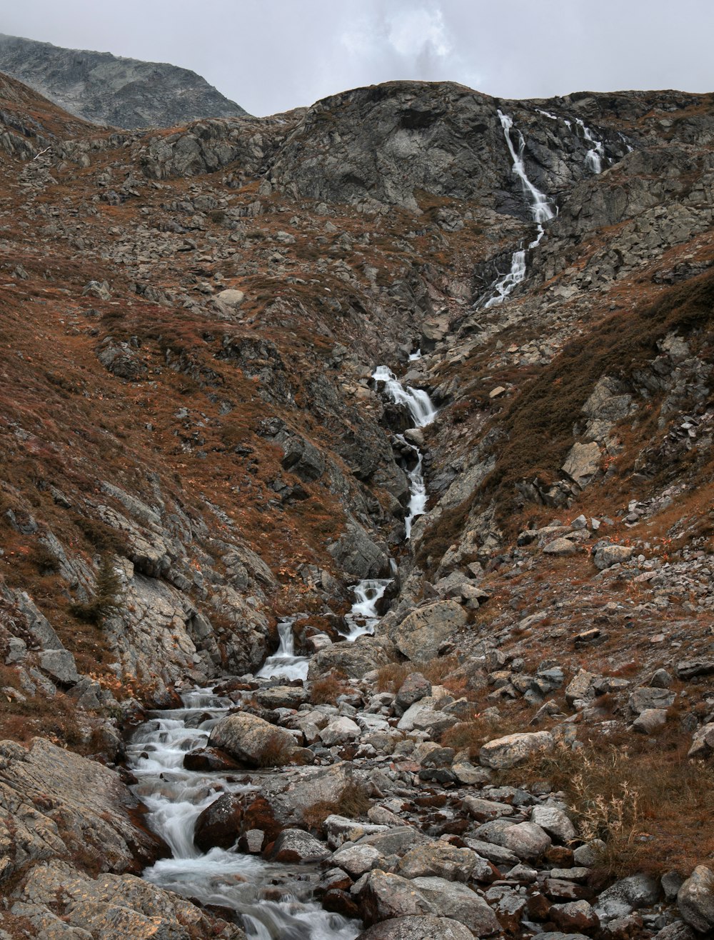 brown rocky mountain with river