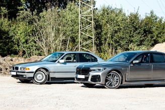black bmw coupe parked beside gray metal tower during daytime
