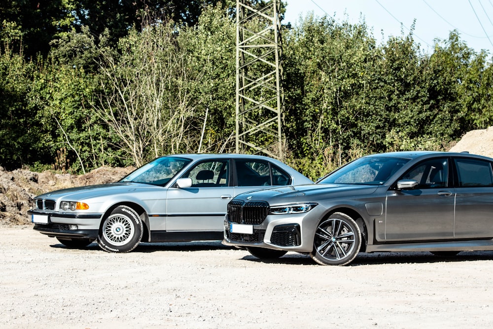 black bmw coupe parked beside gray metal tower during daytime