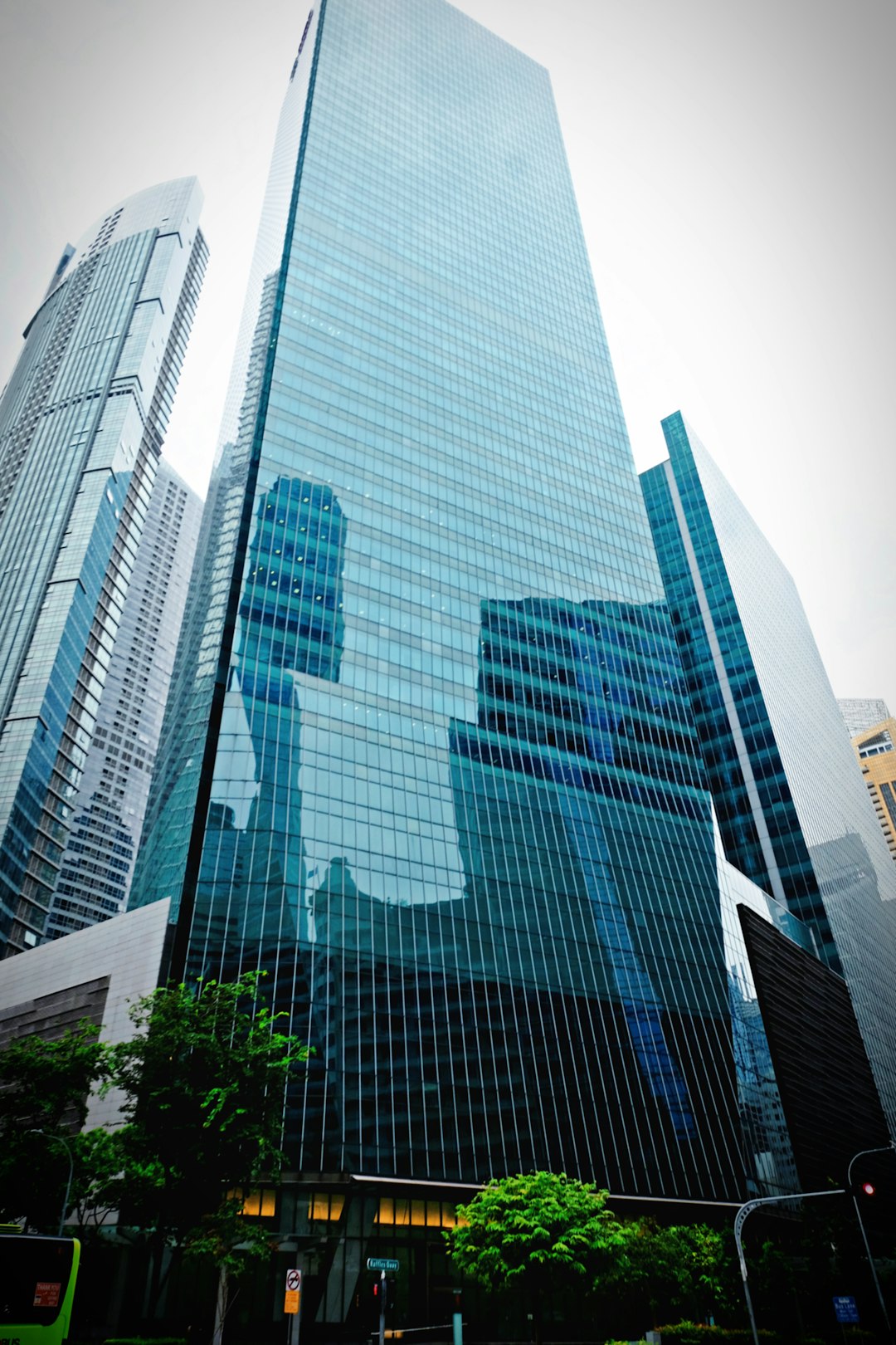 blue and white glass walled high rise building