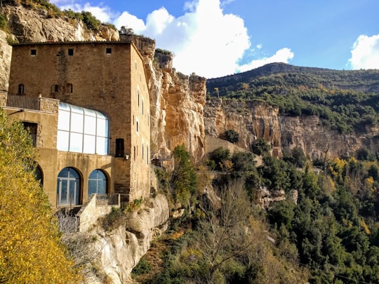 brown concrete building on mountain during daytime in Carretera Sant Miquel del Fai Spain