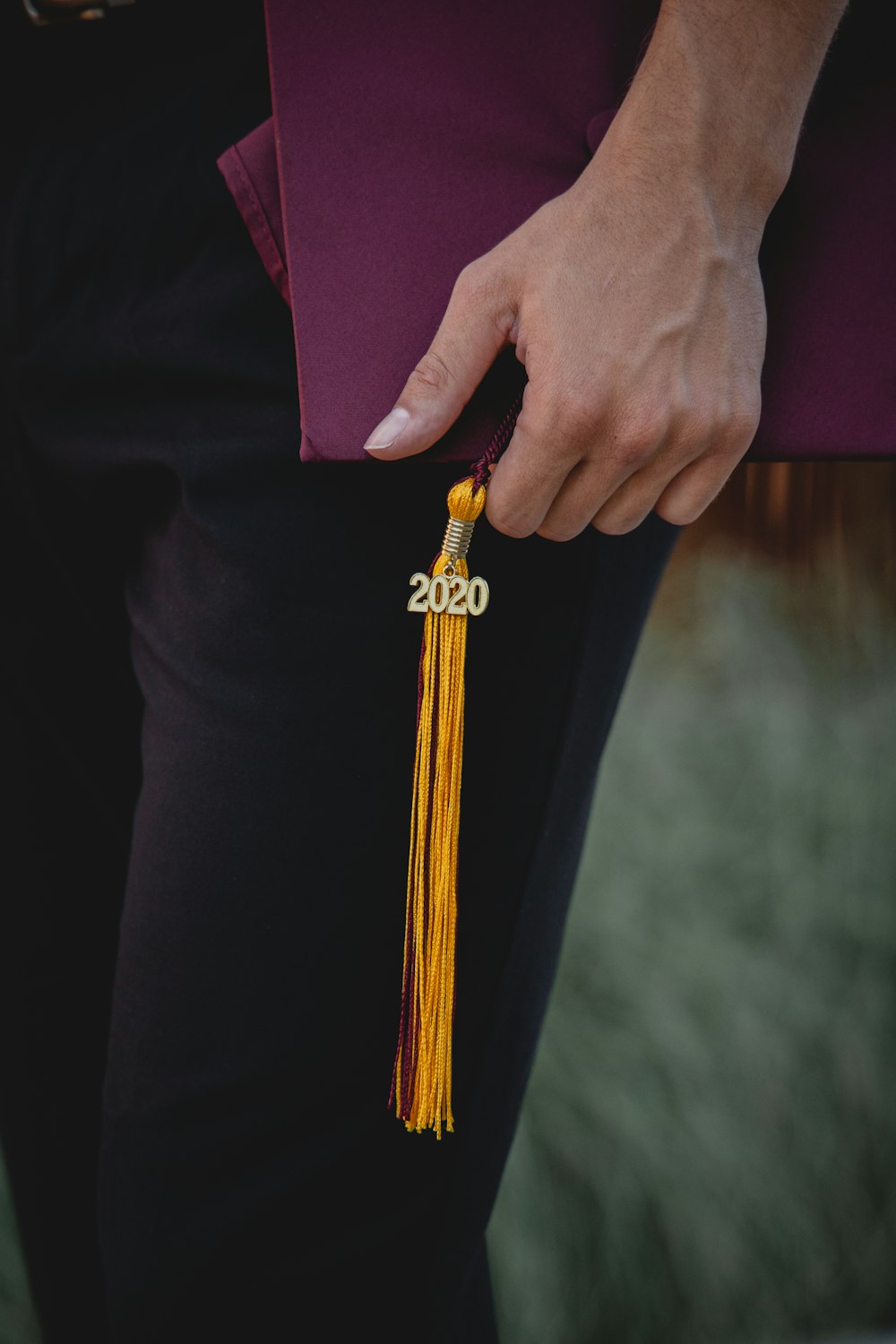 person holding gold and black belt buckle