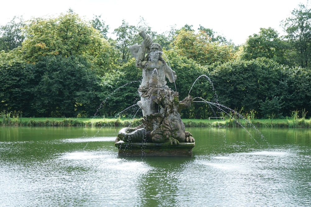 gray concrete statue on water fountain