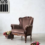 brown leather armchair beside pink roses