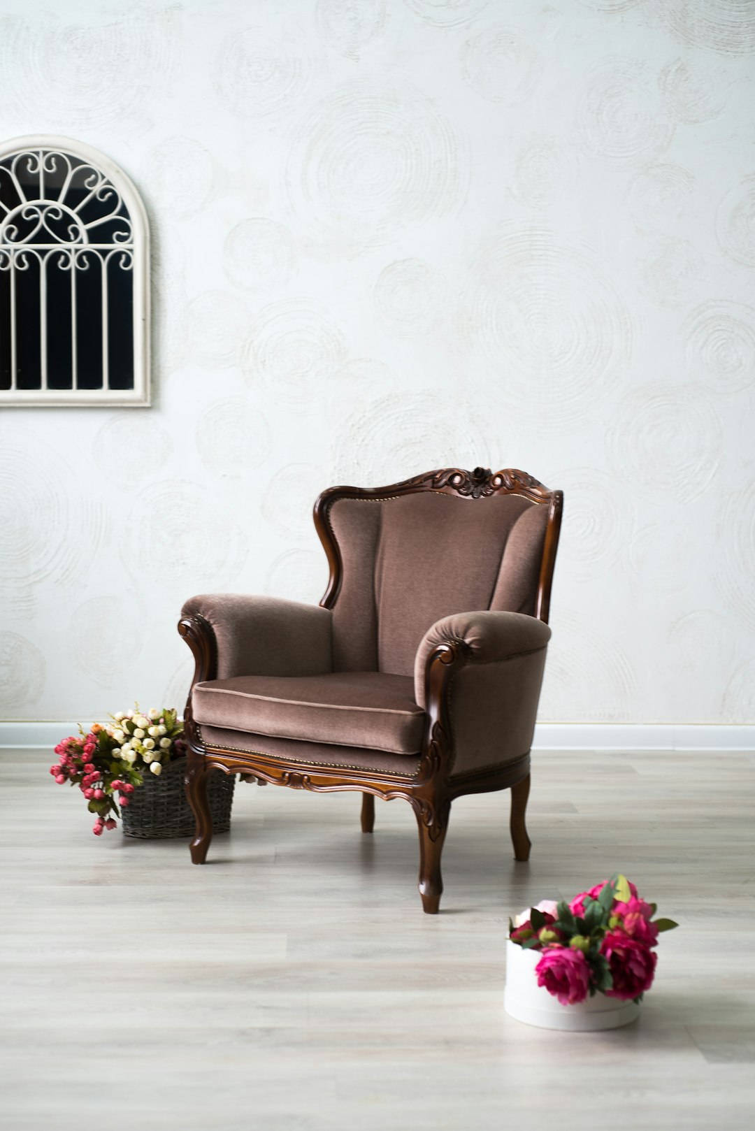  brown leather armchair beside pink roses chair