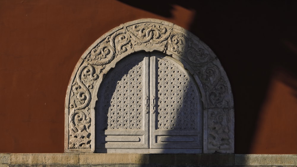 white wooden door on brown concrete wall