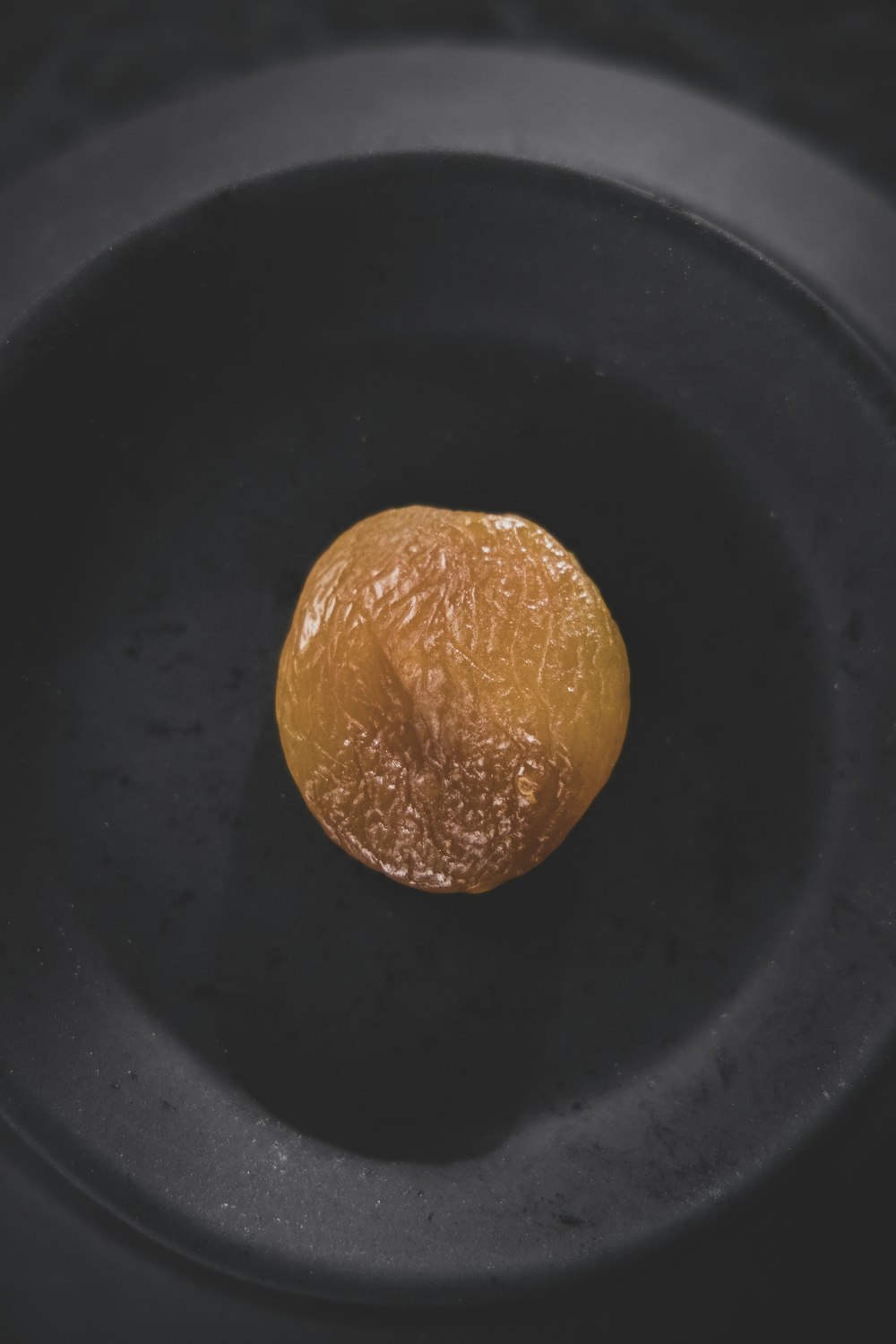 orange fruit on black round plate