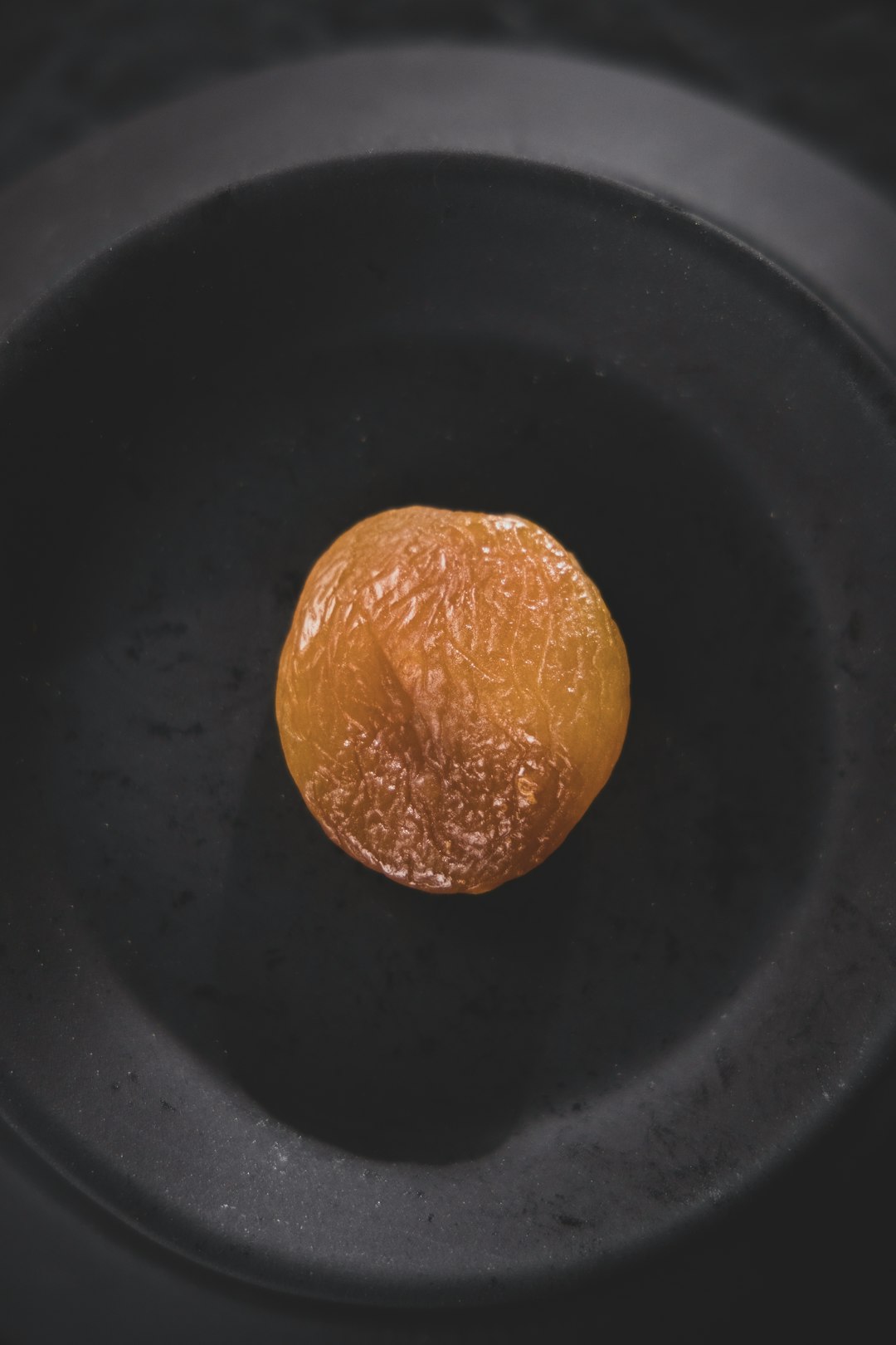 orange fruit on black round plate