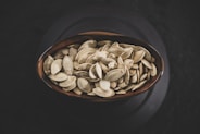brown and white nuts on brown ceramic bowl