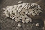 Close-up of raw makhana seeds spread on a rustic wooden surface.