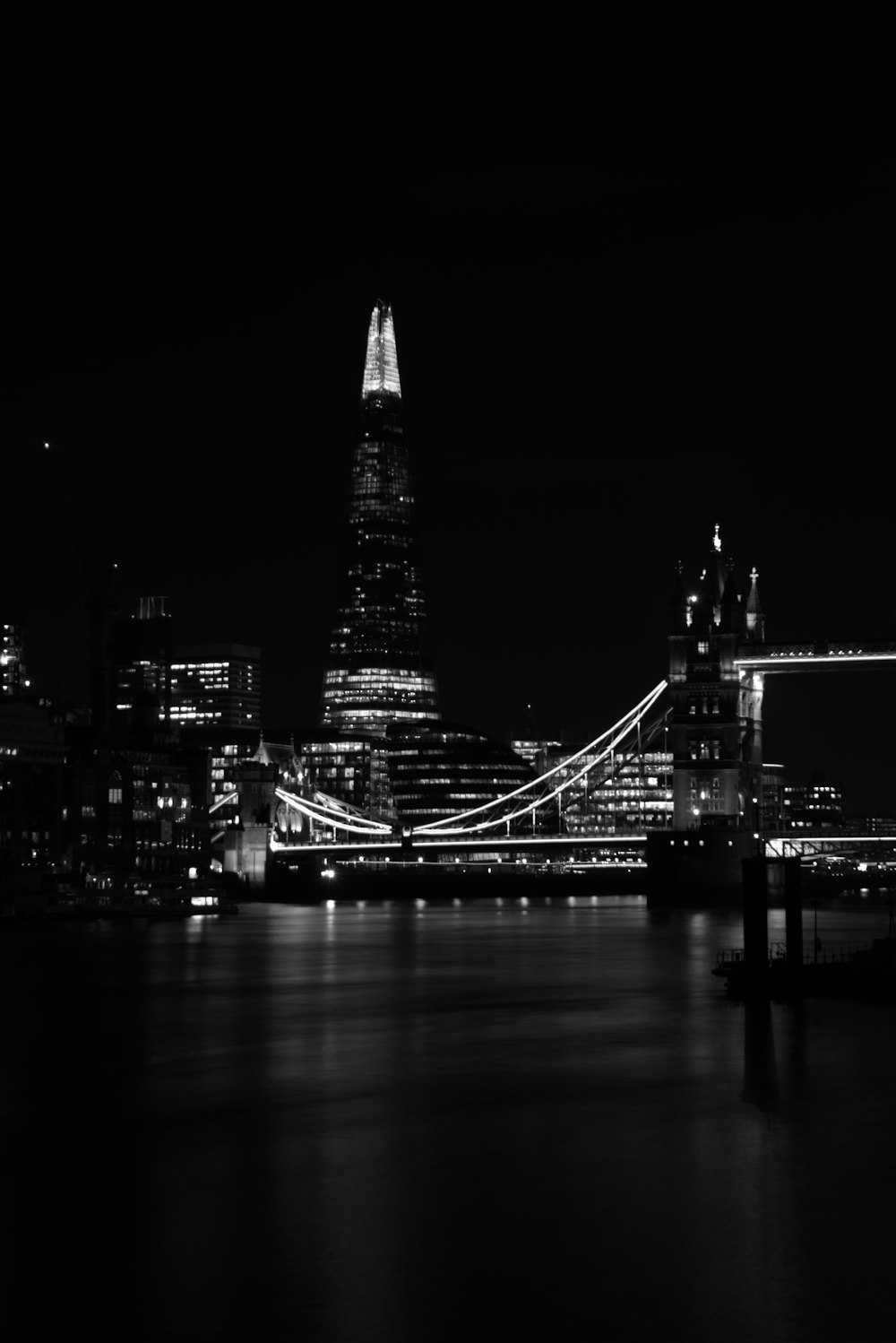 grayscale photo of lighted bridge