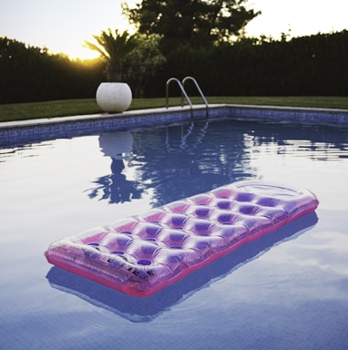 pink inflatable ring on swimming pool