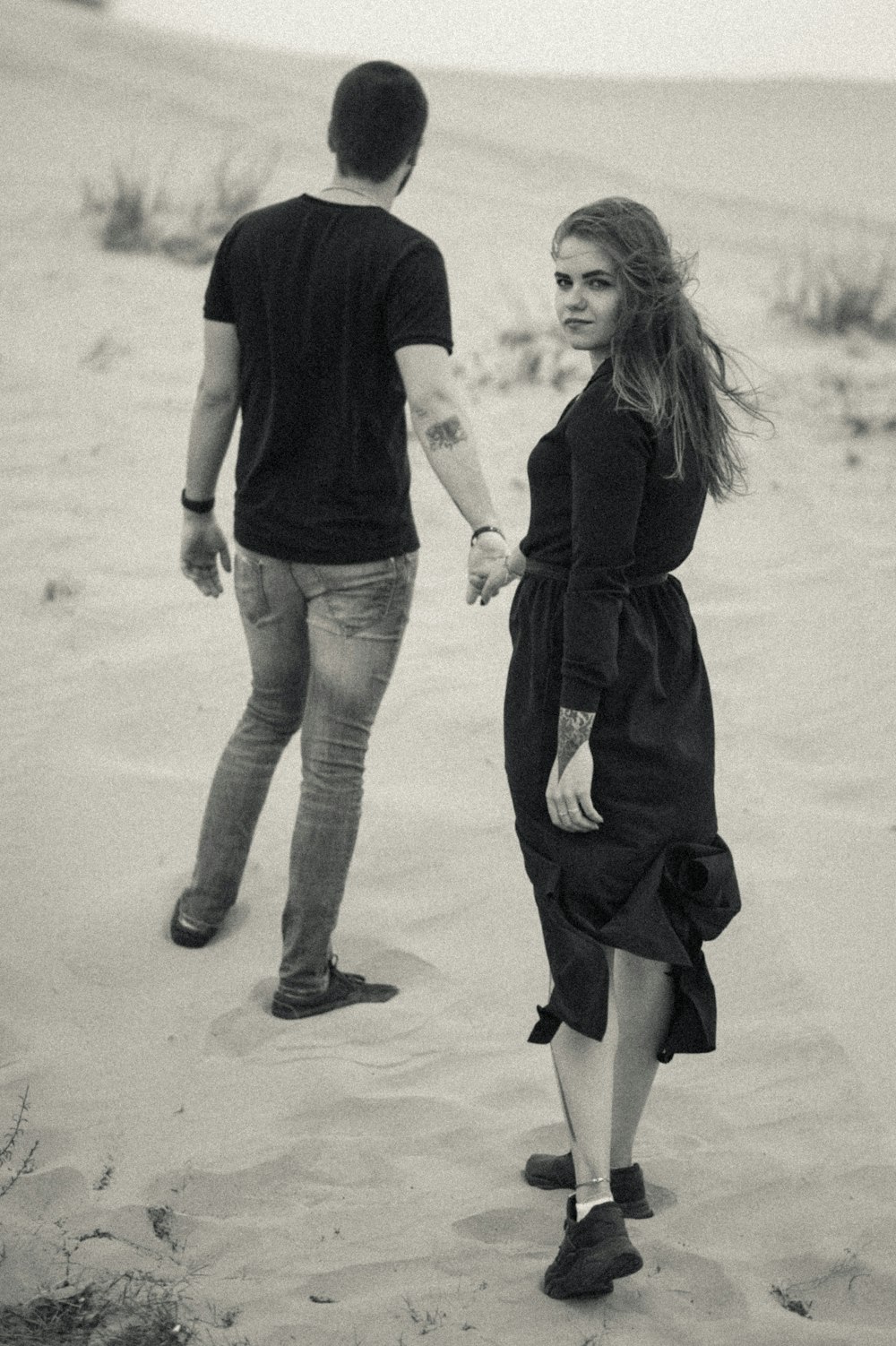 woman in black dress and man in black t-shirt