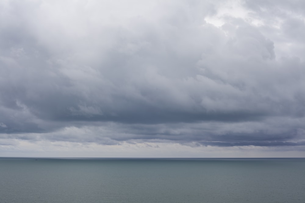 blue sea under white clouds during daytime