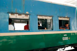 Our team reviewing footage on a laptop beside a vintage train carriage.