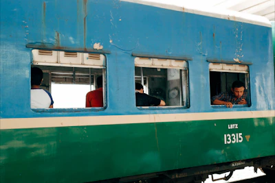 Our team reviewing footage on a laptop beside a vintage train carriage.