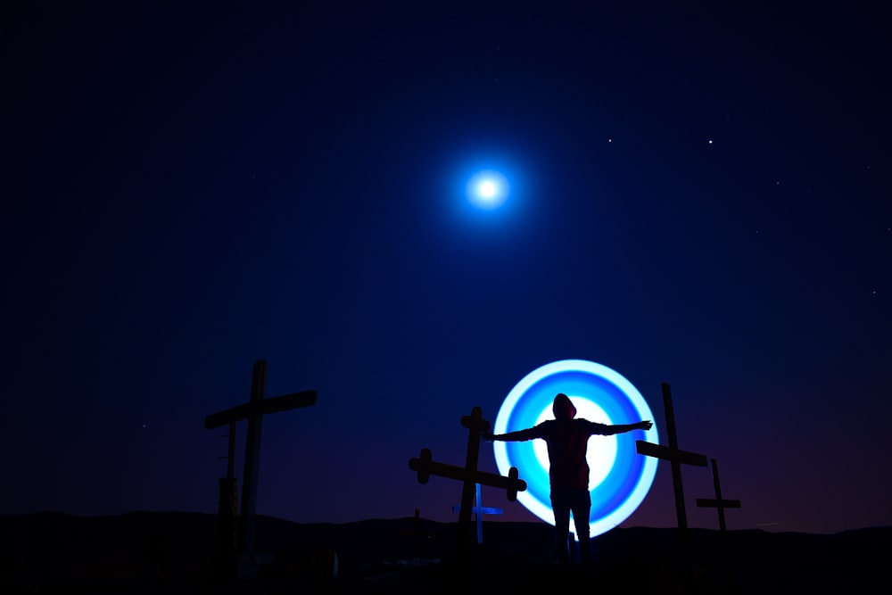 silhouette of cross during night time