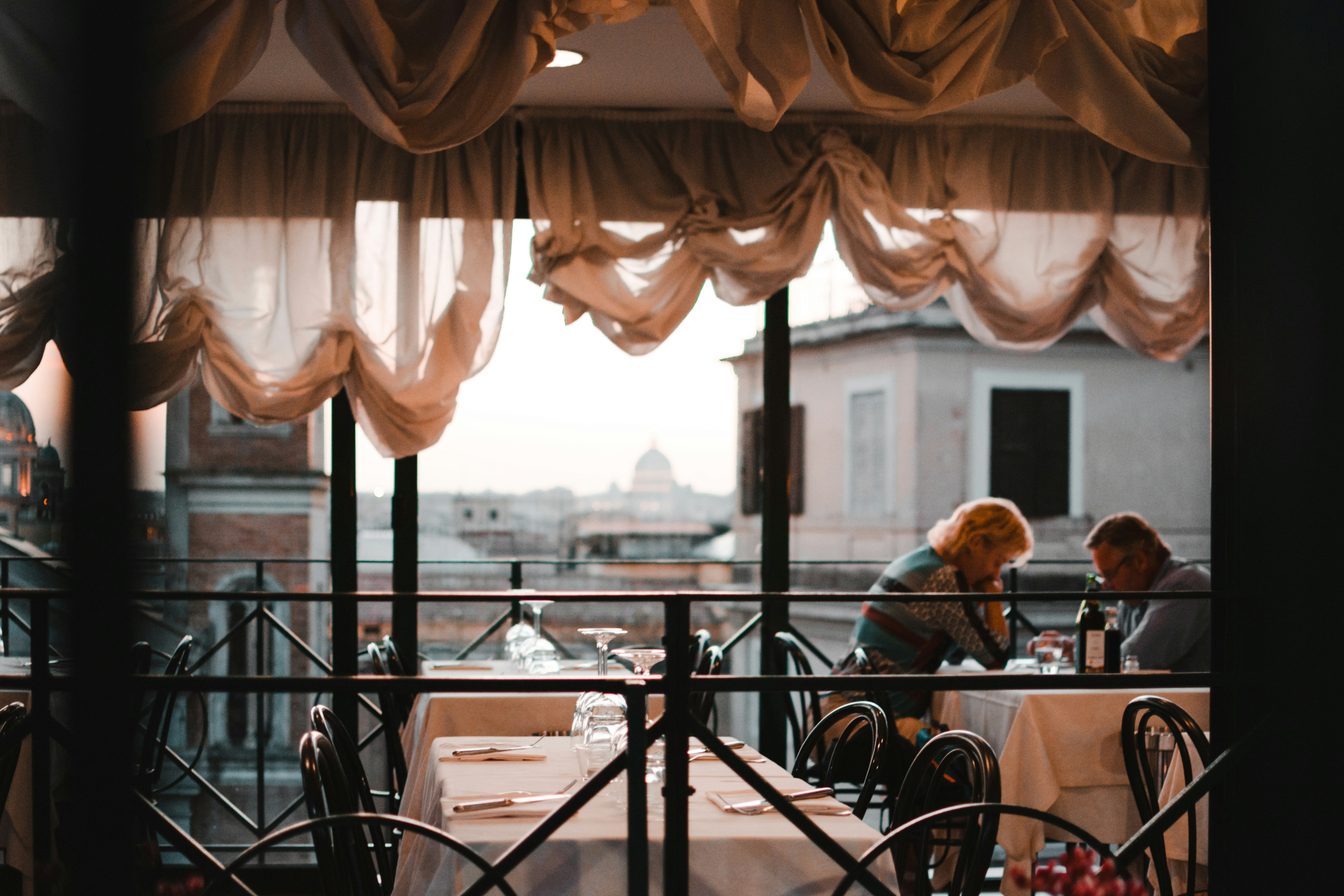 man in black jacket sitting on chair near window