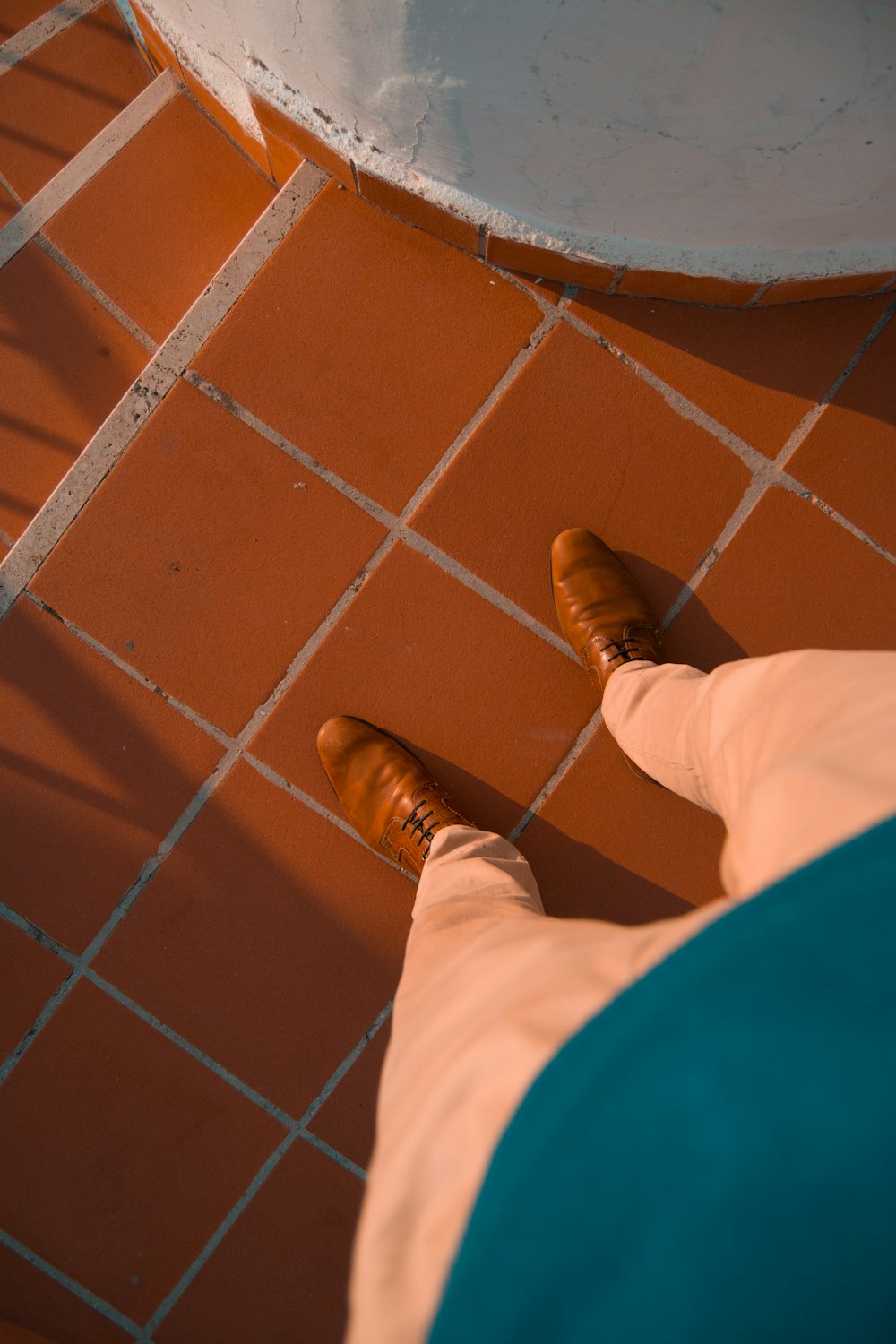 person in brown leather shoes